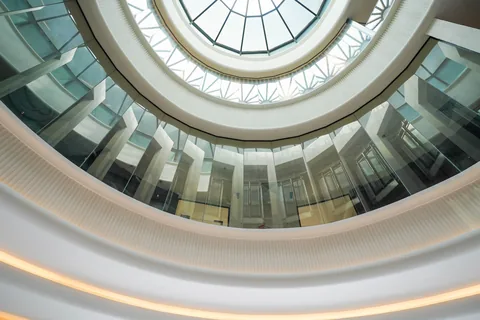 Atrium of Business Square seen from below, ringed by glass balustrades