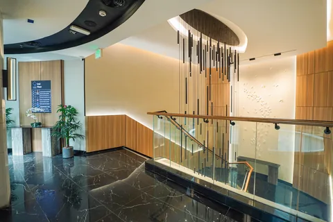 Reception counter and decorative metal screen at Business Square