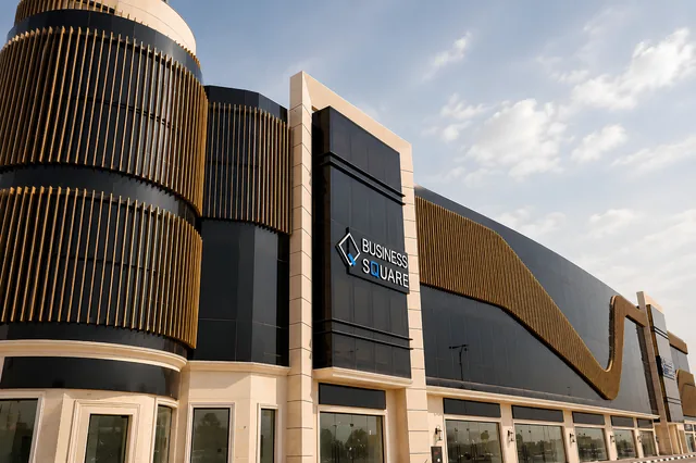 Corner view of the Business Square metal façade and vertical fin drums