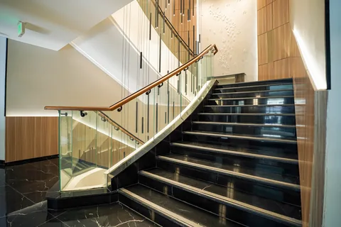 Glass balustrade with a bronze handrail on the main Business Square staircase