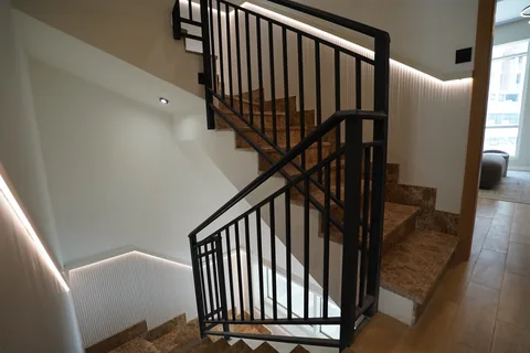 Steel balustrade and timber-clad stair in a Wardana townhouse